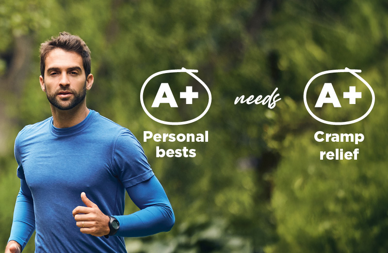 Person running in a blue athletic shirt on a green outdoor trail, with text overlay reading “A+ Personal bests needs A+ Cramp relief.