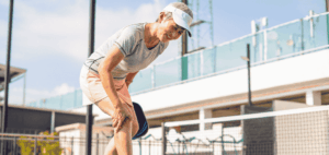 Elderly person struggling with leg cramps and muscle spasms